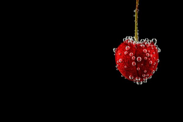 Water bubbles on the surface of the cherry