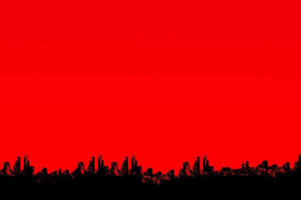 Silhouettes de la ville sur le ciel rouge