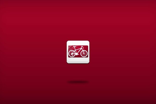 Bicicleta miniatura sobre fondo rojo