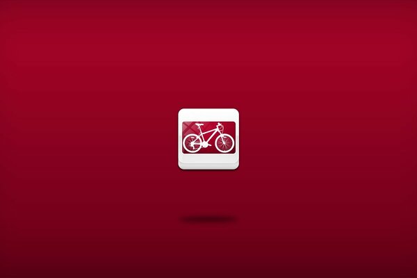 Bicicletta miniatura su sfondo rosso