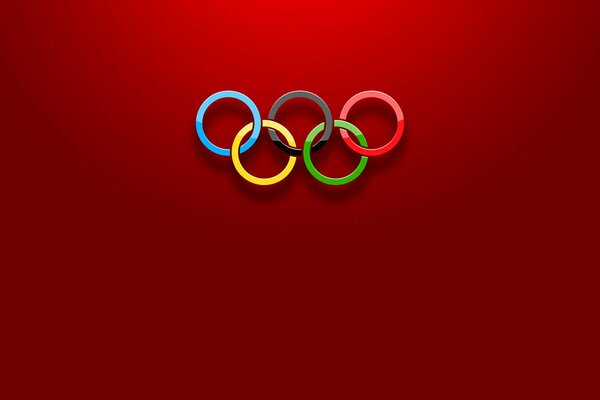 Pierścienie olimpijskie na czerwonym tle