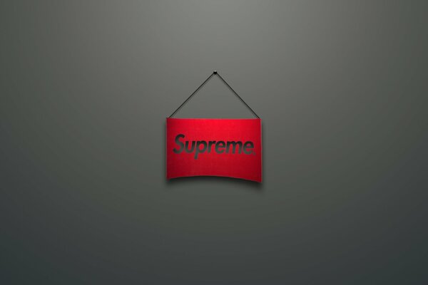 Logo Supreme. sul cartello rosso. Sfondo grigio