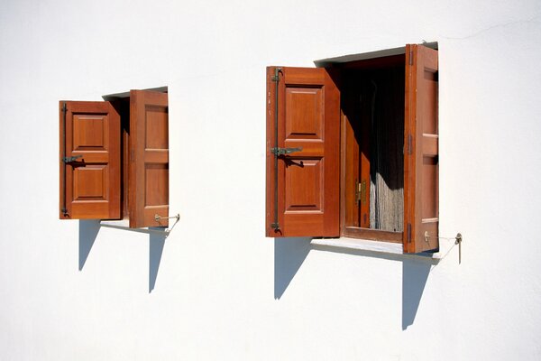 Wooden open windows on a white wall