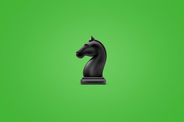 A chess piece, a black knight. Depicted on a green background