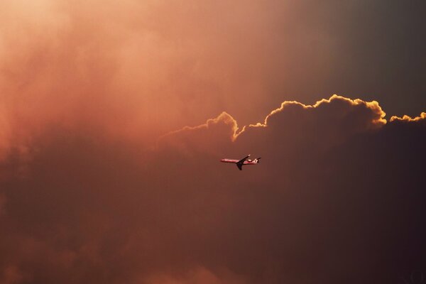 The plane is flying in a cloudy sky