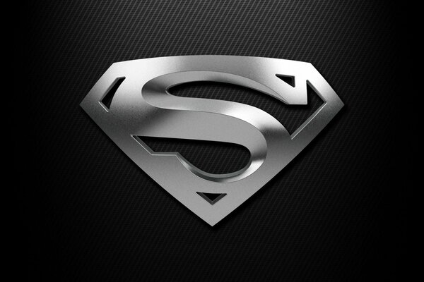 Silver Superman badge on black background