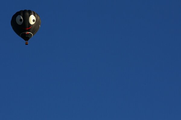 Balloon with a muzzle on the sky background