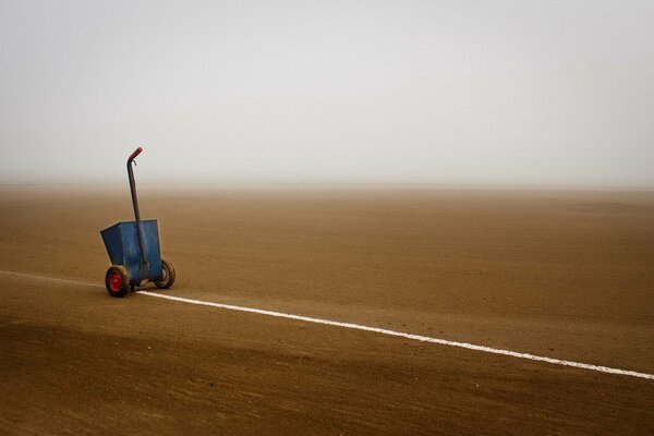 A car leading a white line across the field