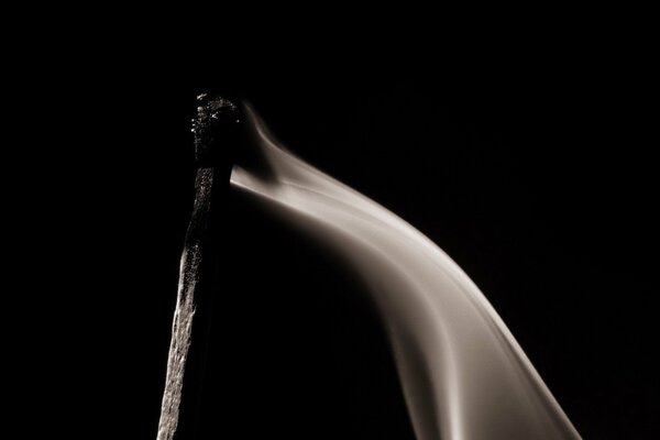 Smoke from a match on a black background