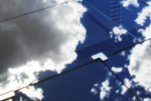 Reflection of the sky with clouds in glass