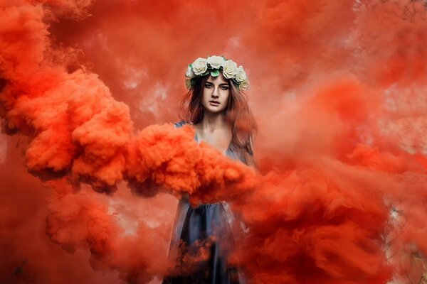 Dziewczyna z wieńcem na głowie w czerwonym dymie