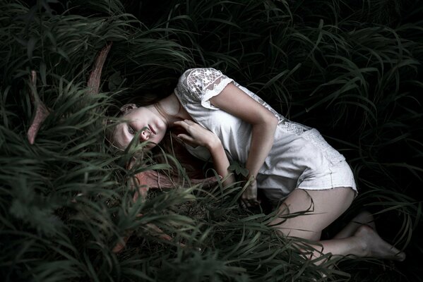 Jeune fille se trouve les yeux fermés dans l herbe