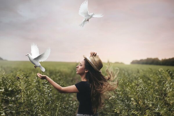 A girl with pigeons and in nature