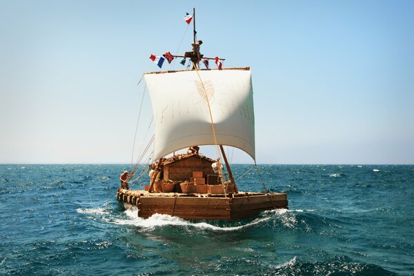 Balsa con vela blanca en el mar azul