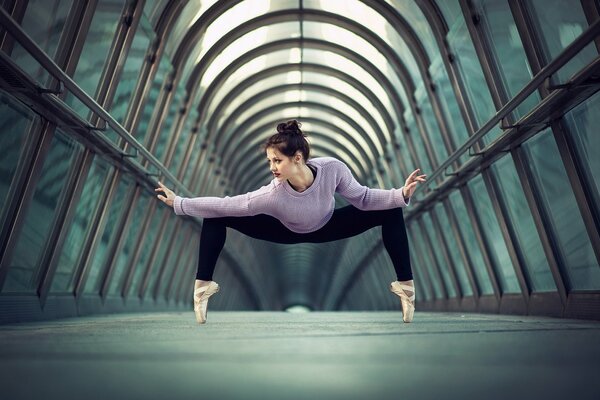 Graceful ballerina stands on pointe shoes