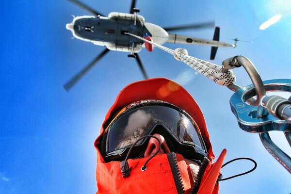 The rescuer flies in the sky, holding a carbine