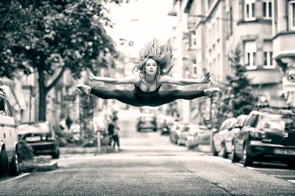 Jump of a sporty girl on a city street