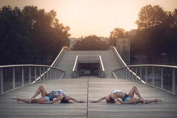 Two gymnasts on a wooden bridge