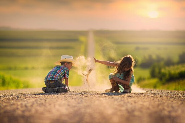 A boy and a girl play on the road