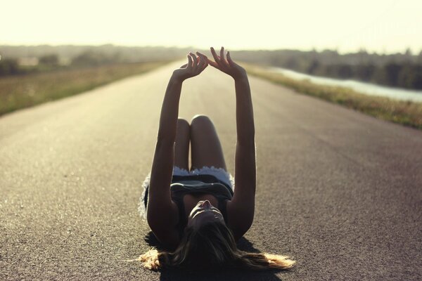 The girl is lying on the road