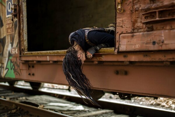 The girl lowered her head from the train car