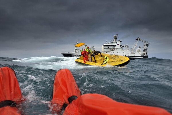 The situation of rescuing yacht passengers by lifeguards on a boat in the ocean