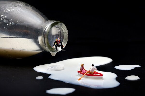 Micro people are floating in a boat on spilled milk