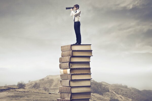 The guy looks through the telescope standing on a stack of books