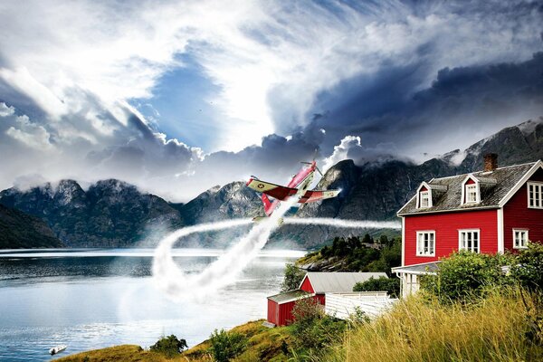 A plane in the sky near a house and a lake