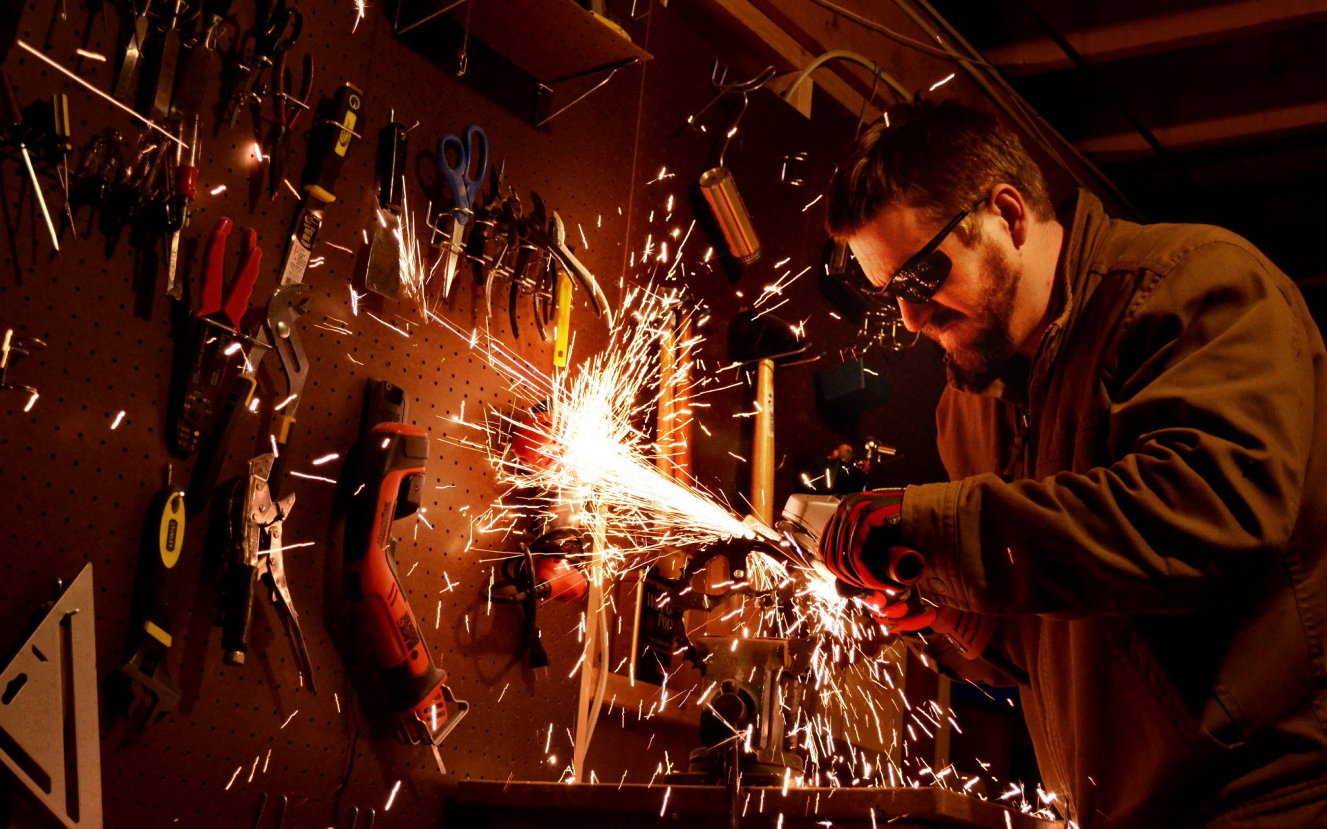 a man beard sunglasses sparks tools cutter