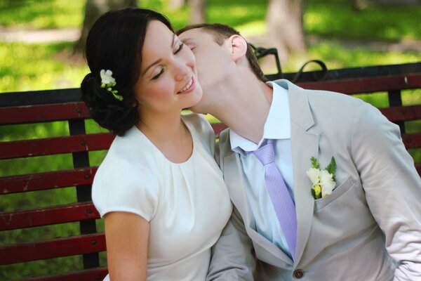 The groom kisses the bride at the wedding