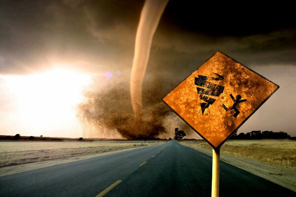 Tornado on the road and a danger sign