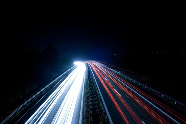 The blurred light of cars on the night road