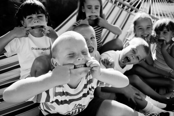 Grimacing children on a hammock