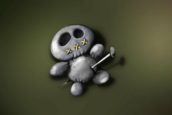 A voodoo doll toy with a needle