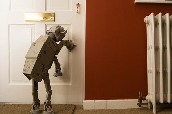 The robot tries to open the door