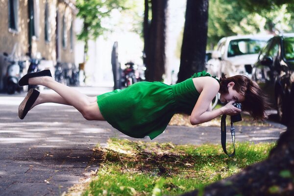 Soaring girl taking pictures of grass