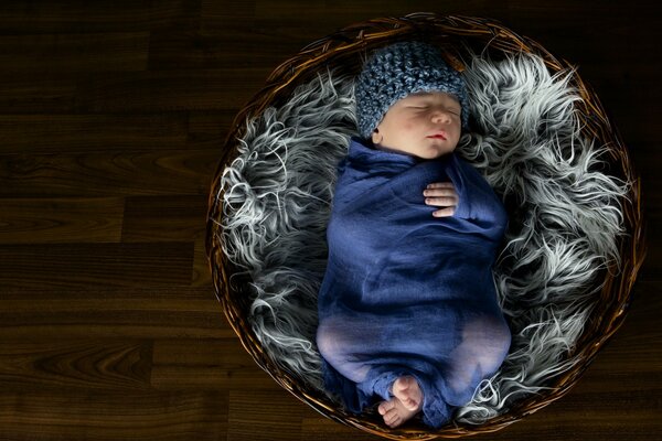 The baby sleeps in the basket