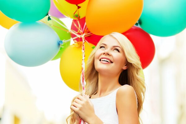 Happy blonde with balloons