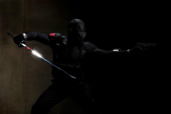 A black ninja with red shoulder straps is ready for battle