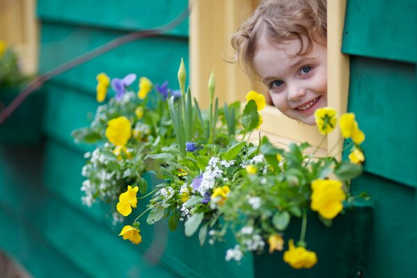 Cute girl in a house with flowers