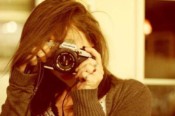 Portrait of a girl holding a camera