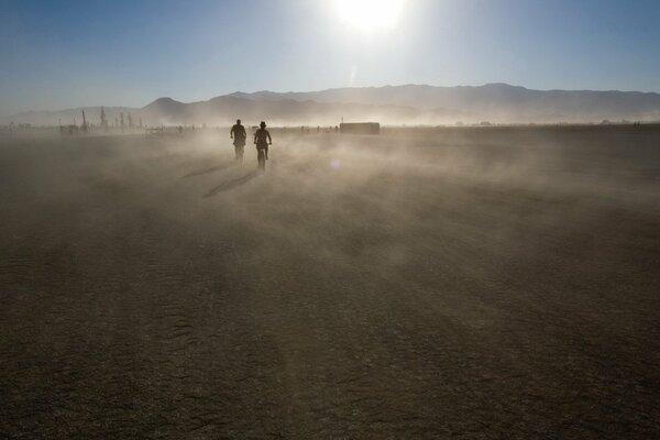 Two against the background of mountains in the dust