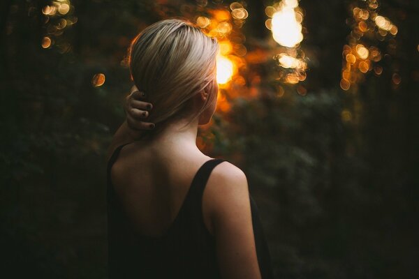 Blonde in a black dress with an open back