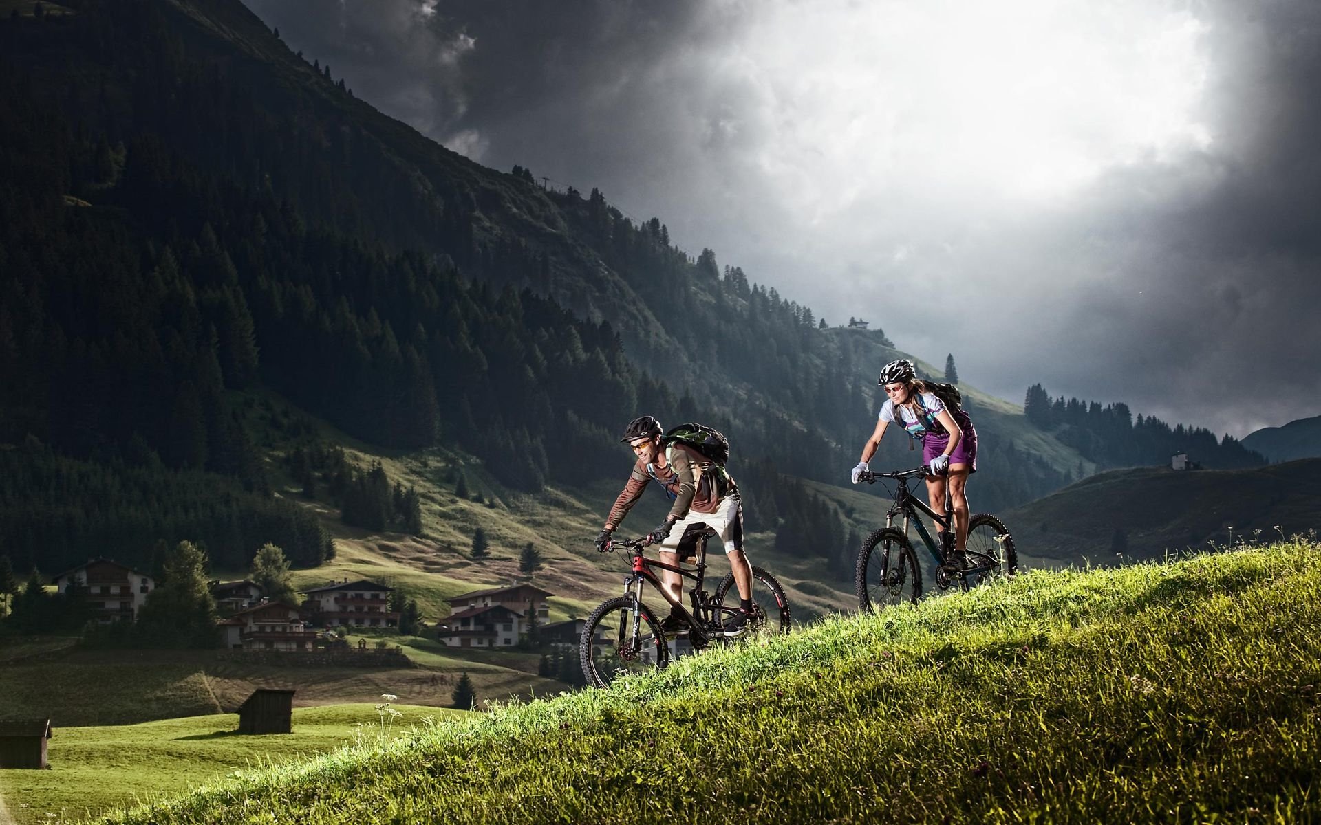 men a woman cyclists tourists mountain alps nature