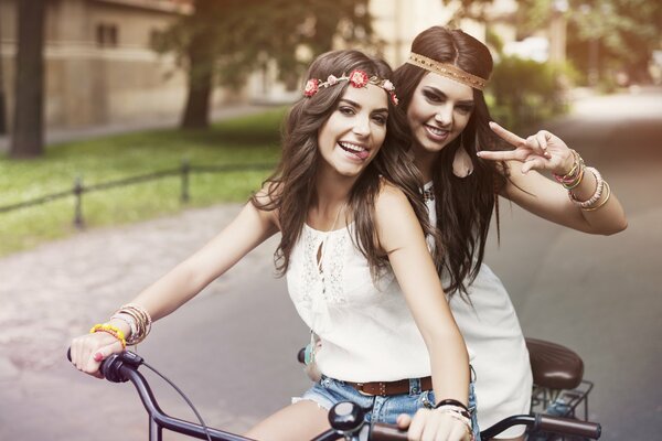 Friends ride a bike in a good mood