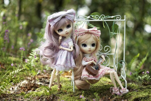 Two dolls on a swing