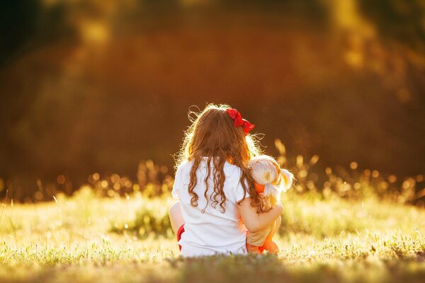 Une fille avec un arc dans les rayons de la lumière du soleil