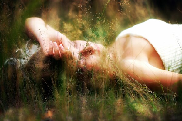 Chica acostada en la naturaleza en la hierba