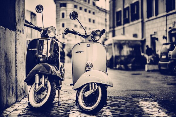 Two scooters. Tall houses